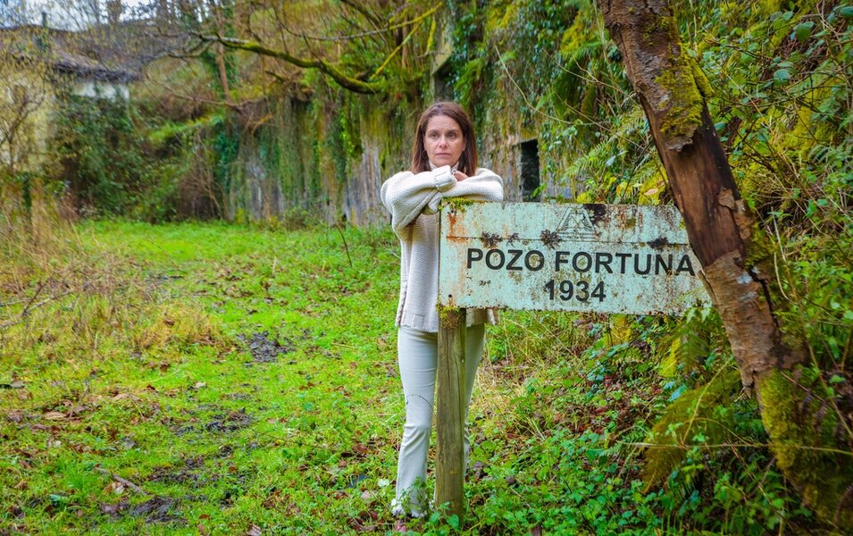 Leticia Sierra ente el cartel del Pozo Fortuna del Valle de Turón, en Asturias