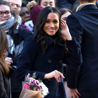 Meghan Markle sonriente en su primer acto público tras el compromiso con el Príncipe Harry
