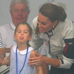 La Princesa Carlota sacando la lengua ante la mirada risueña de su madre