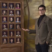 Juanra Bonet ante los retratos de los participantes de 'Traitors España'