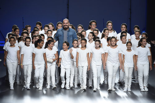 Juan Duyos con un coro de niños en su desfile de la colección primavera/verano 2015 en Madrid Fashion Week